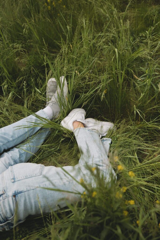 Couple's legs intertwined in the grass