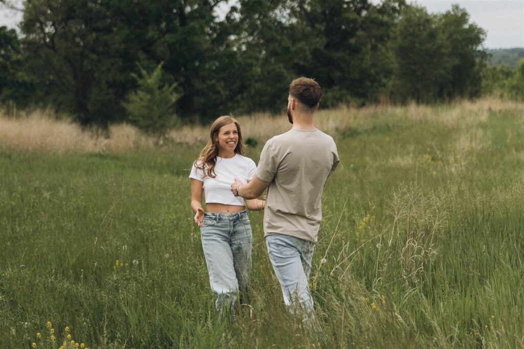 Man and woman walk towards each other with open arms