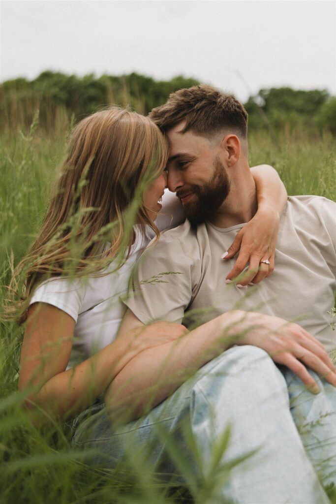 Man leans back into woman as they touch noses before going in for a kiss