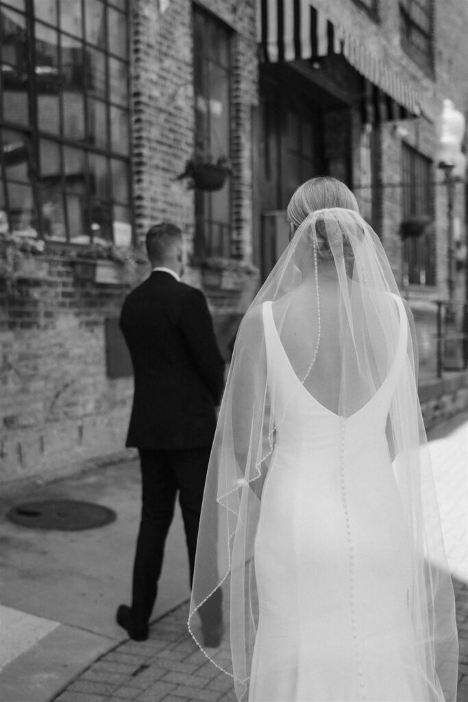 Bride approaches groom in microwedding first look