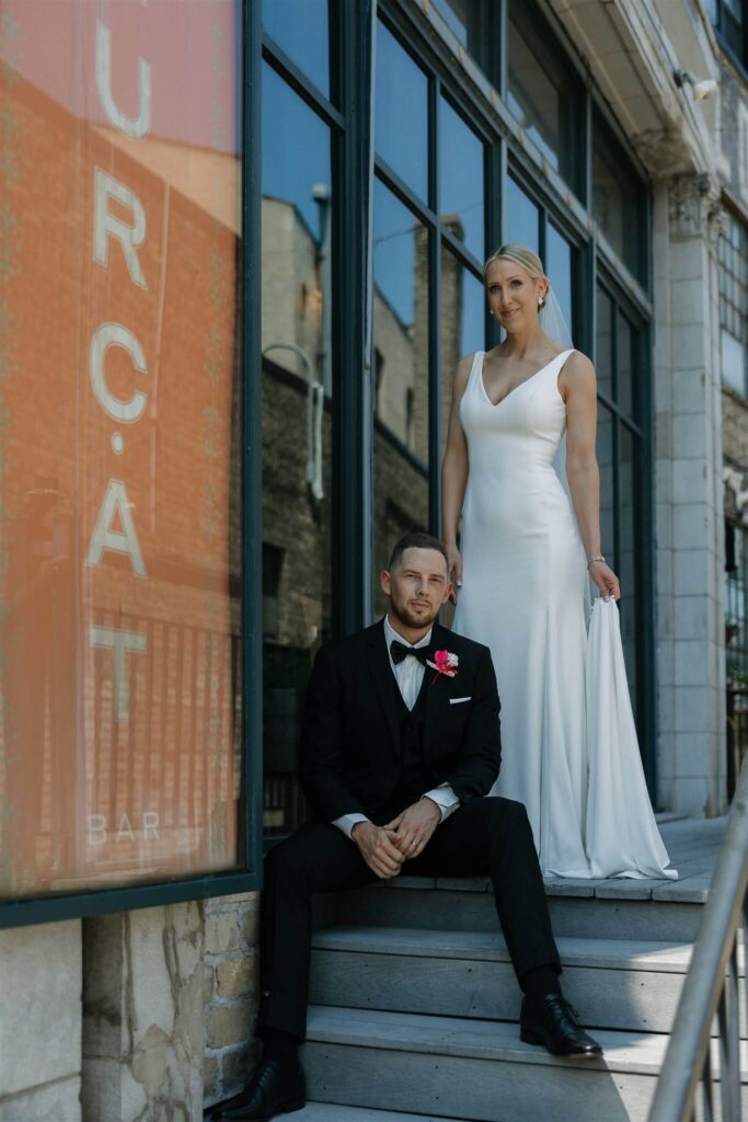 Bride and groom pose on steps outside Bar Lurcat in downtown Minneapolis