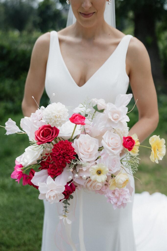 Bride holds her colorful microwedding bridal bouquet