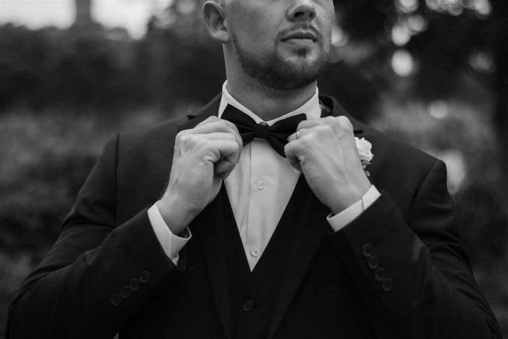 Groom fixes his bowtie before microwedding ceremony