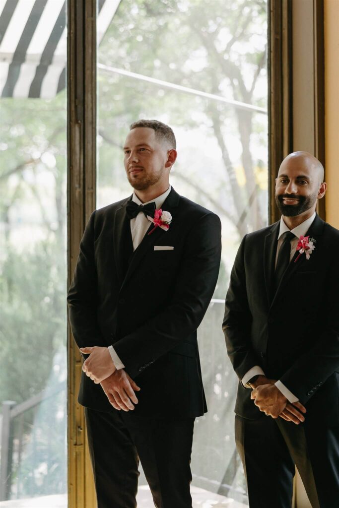 Groom smiles softly as bride approaches up the aisle