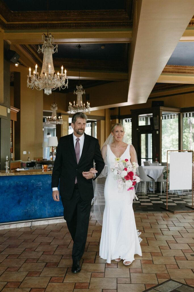 Bride and father of the bride emotionally make their way up the aisle of microwedding