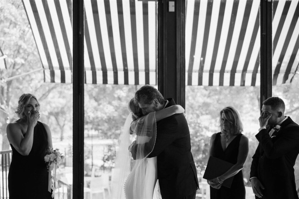 Father of the bride hugs his daughter before handing her off to her husband-to-be