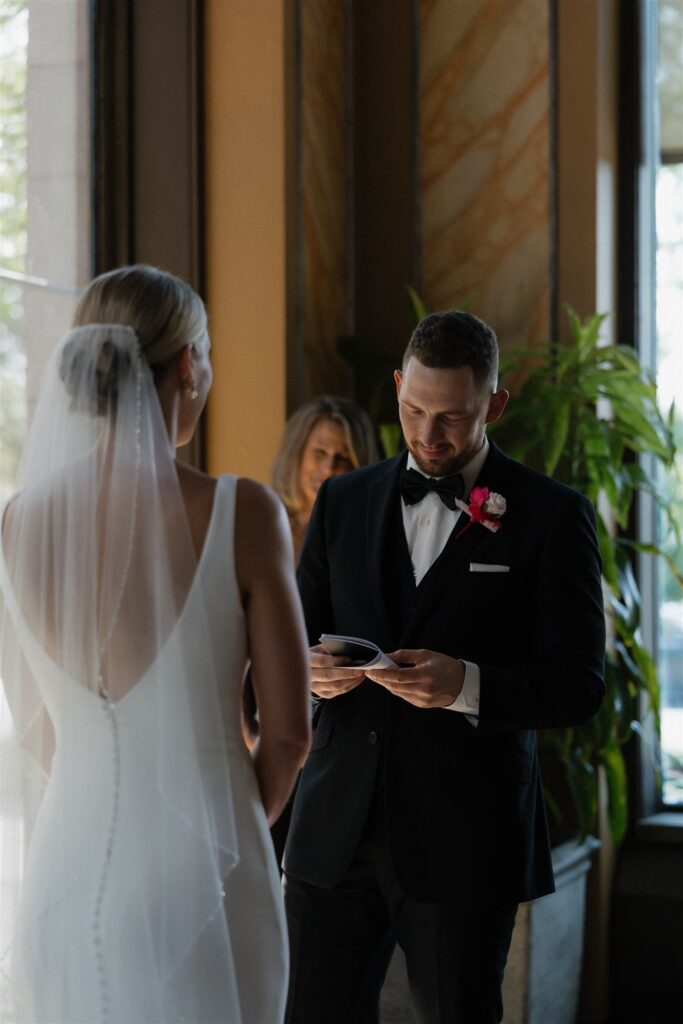 Groom reads his vows to his bride in microwedding