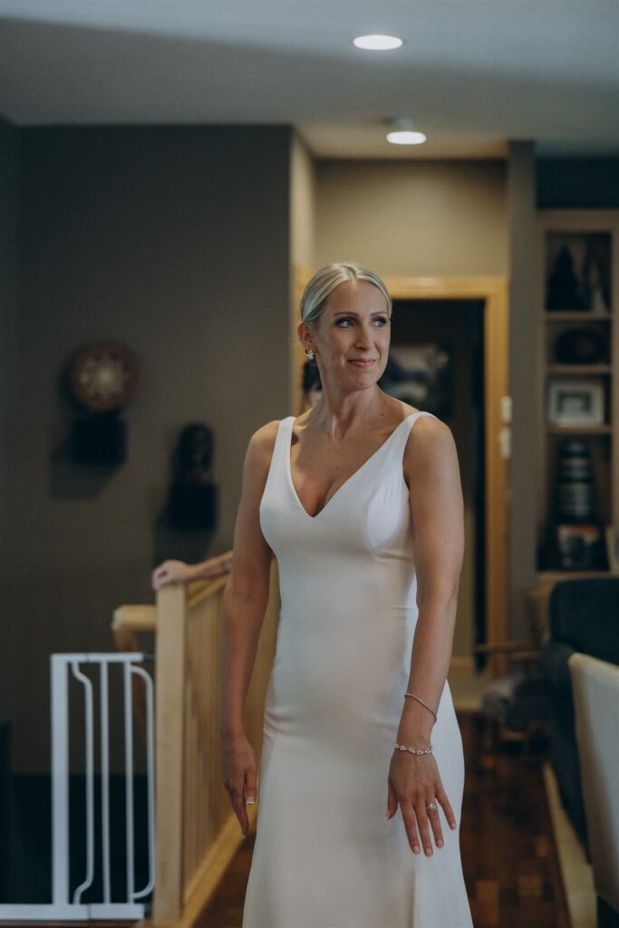 Bride stands in her childhood home before microwedding in downtown Minneapolis