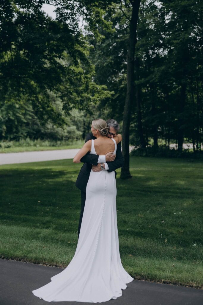 Bride and her father hug