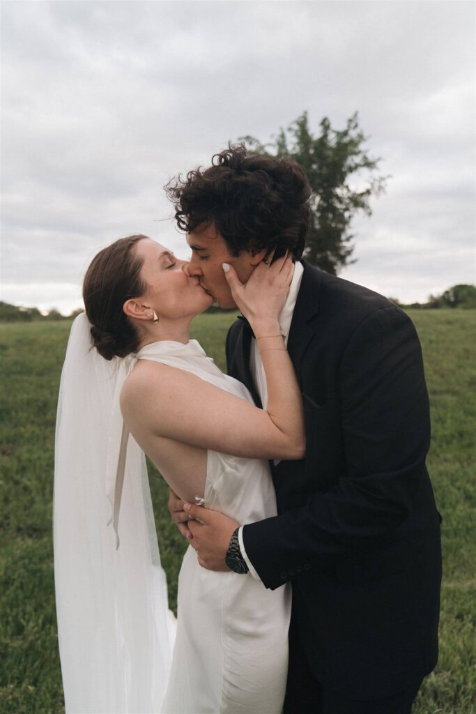 Bride and groom kiss on stormy and windy wedding day in Minnesota