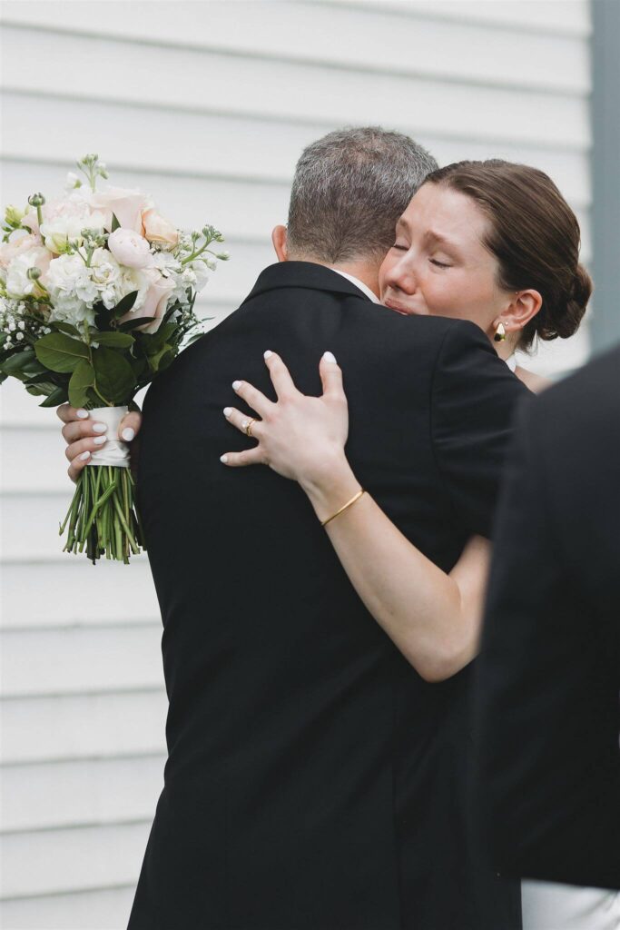 Bride embraces her father in emotional hug during wedding first look