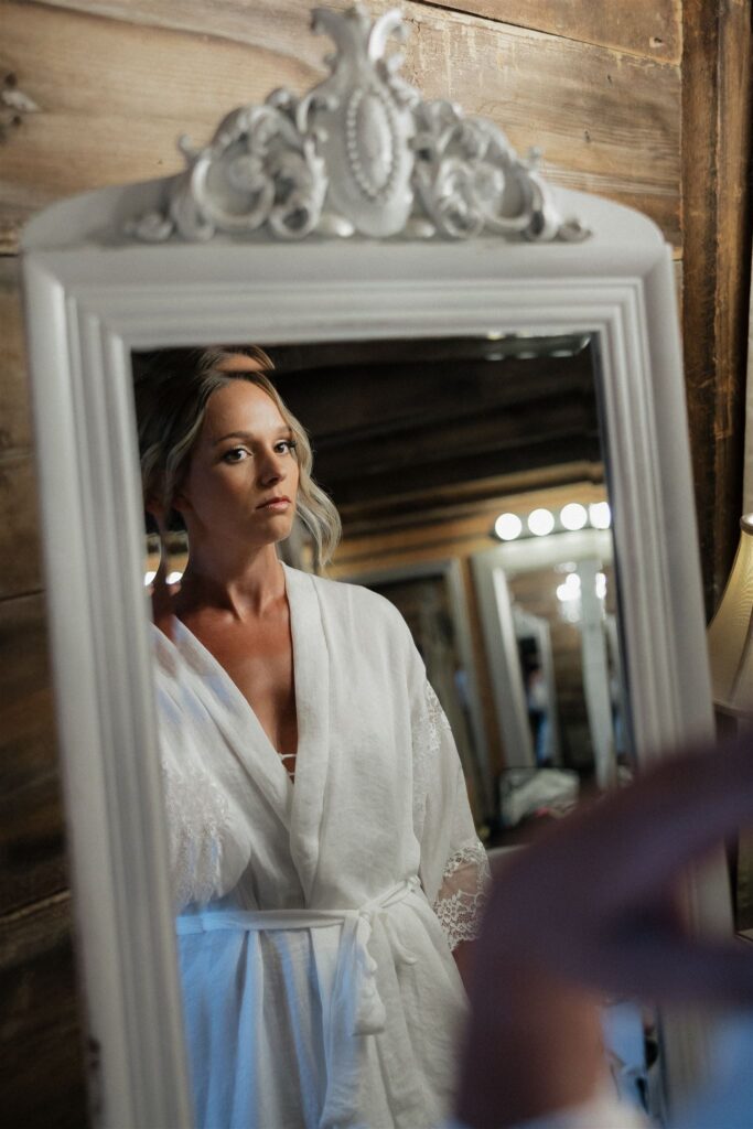 Bride inspects her appearance in the mirror 