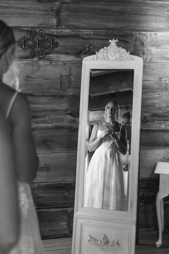 Bride admires her appearance in the mirror