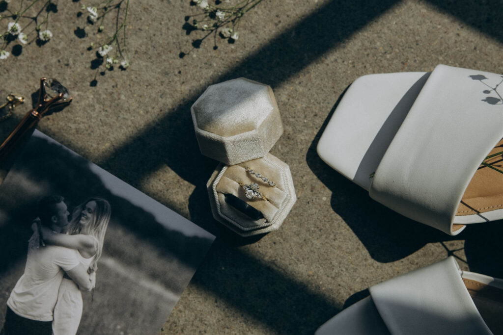 Bride's rings and the Save the Date, along with her shoes are scattered along the floor