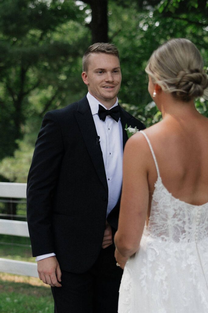 Groom grins as he sees his bride for the first time