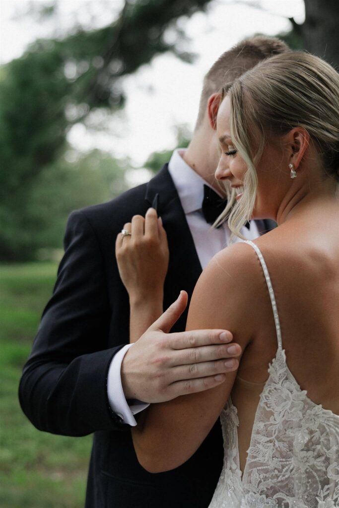 Bride and groom embrace during first look at Minnesota farm wedding venue