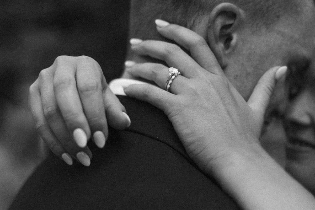 Bride's hands rest around her groom's neck