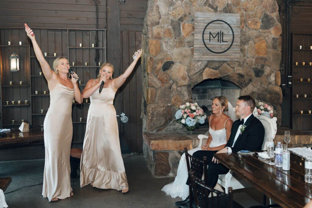 Bridesmaids rap their speech while bride and groom look on