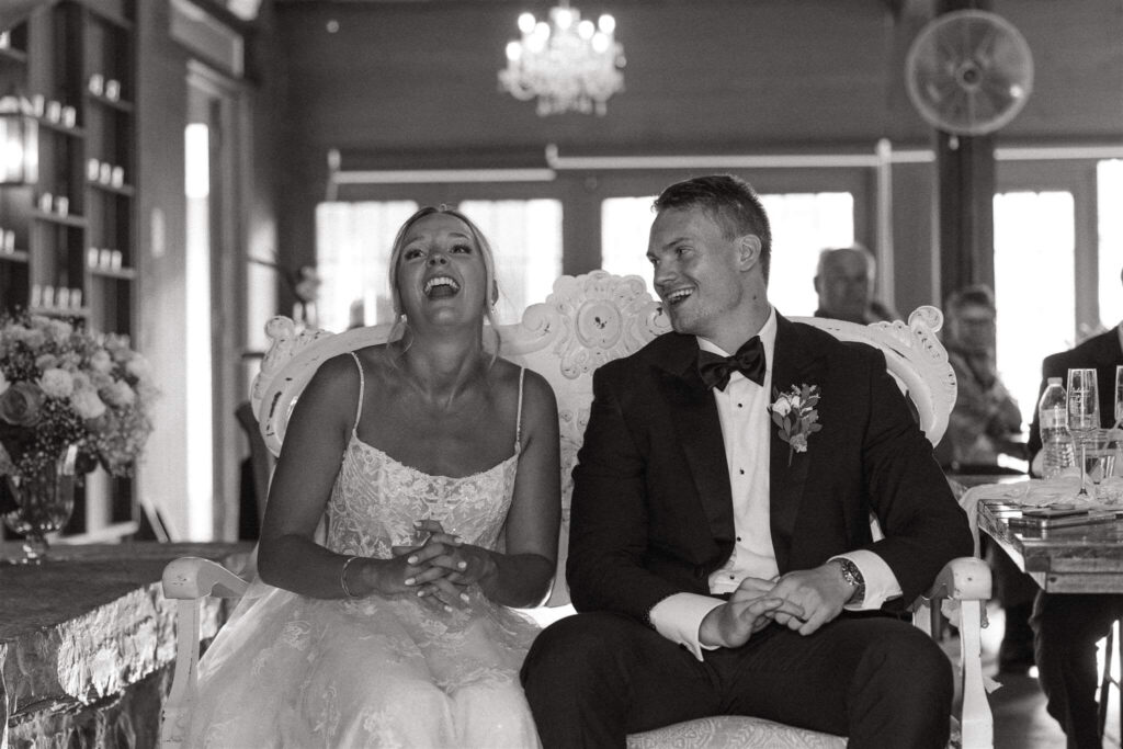 Bride and groom laugh at wedding speeches at Hope Glen Farm wedding venue