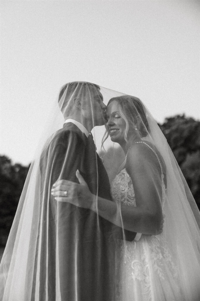 Groom kisses bride's forehead