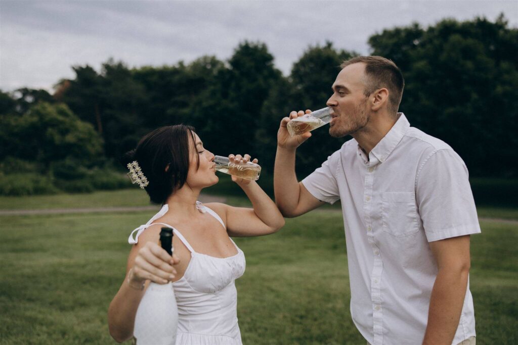 Engaged couple sips champagne to celebrate their engagement