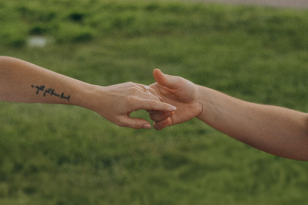 Engaged couple clasps hands