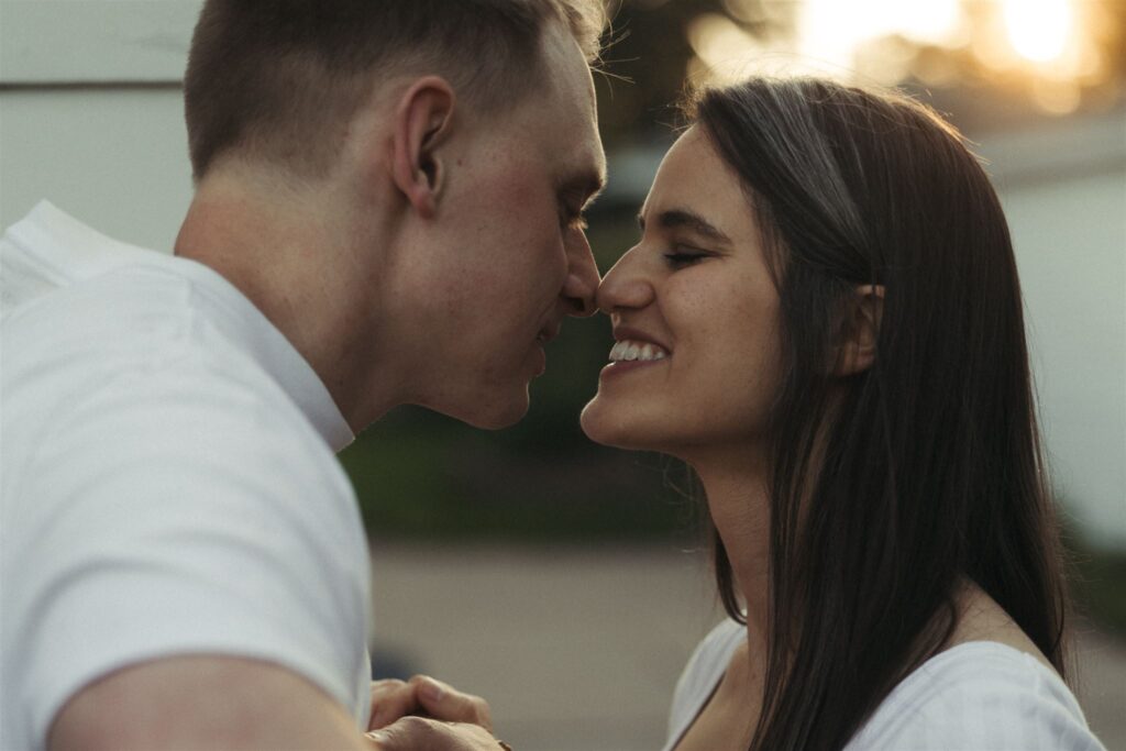 Engaged couple kisses at golden hour