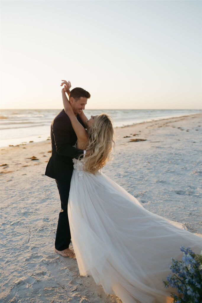 Bride and groom dance on the beach at their destination elopement