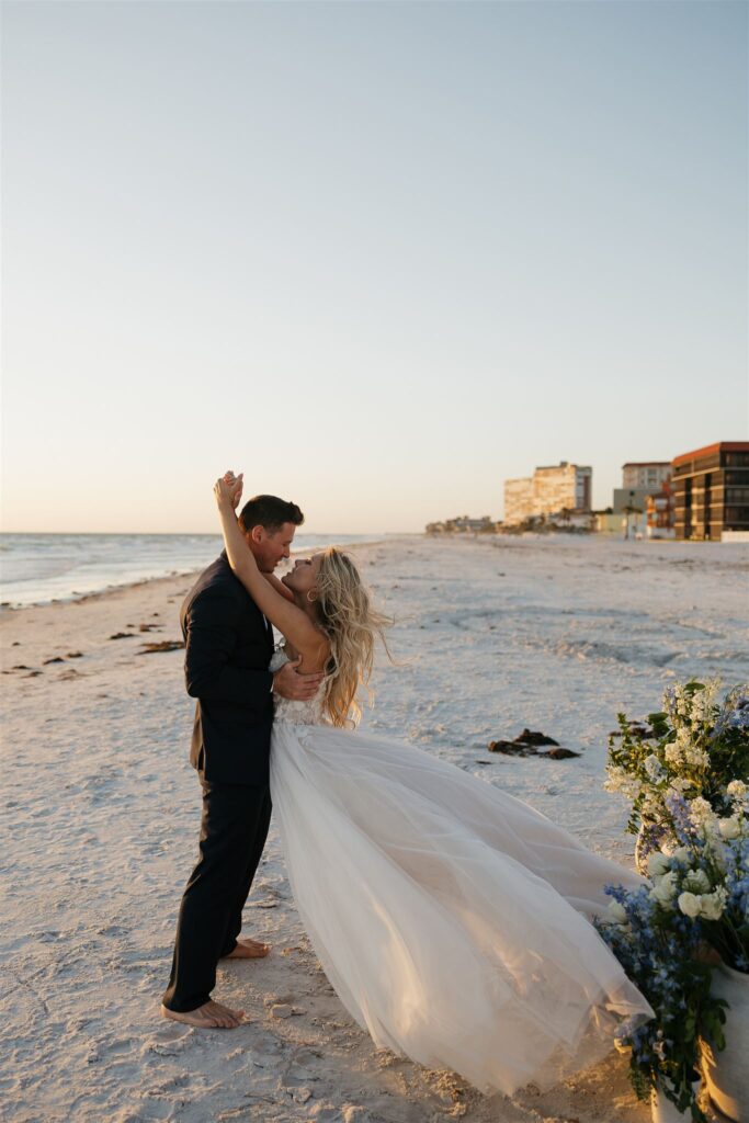 Newlyweds embrace in intimate moment on Florida beach