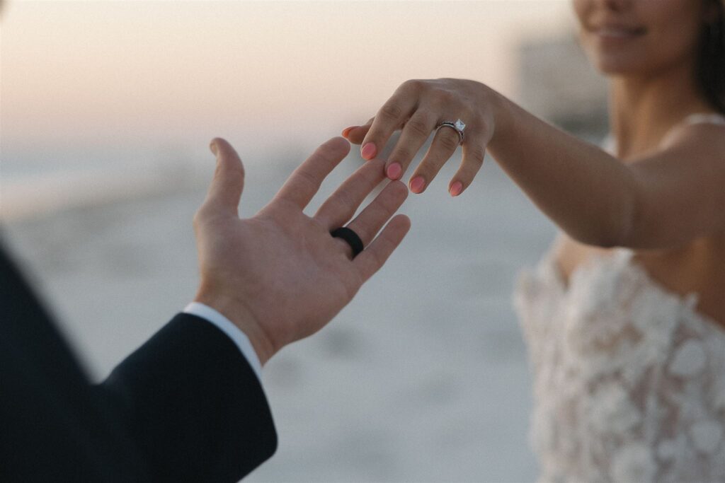 Bride reaches for groom's hand