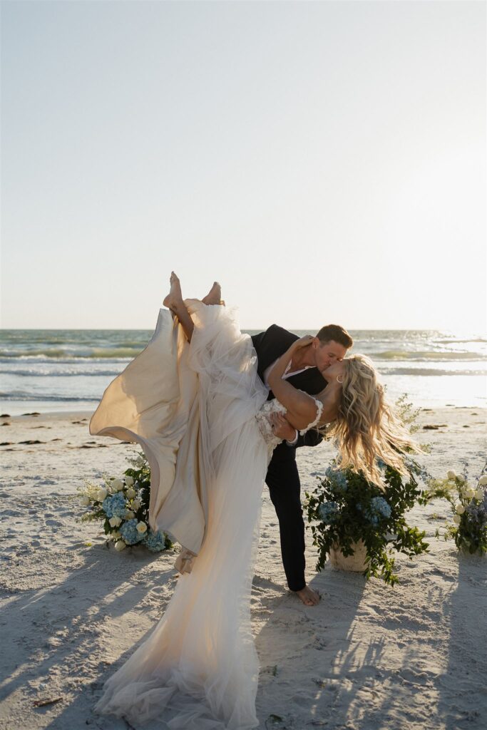 Groom dips bride in romantic destination elopement kiss at the end of their ceremony