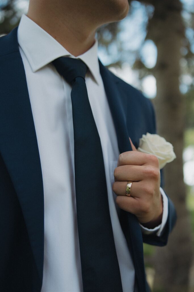 Groom fixes his jacket