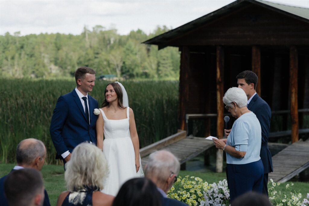 Bride looks up at groom as officiant reads wedding vows