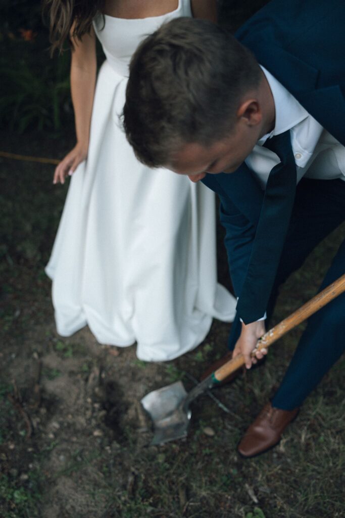 Groom digs with a shovel