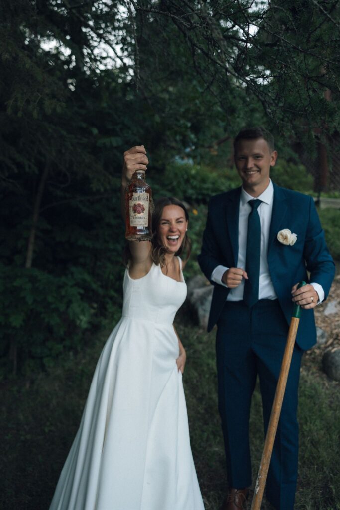 Bride holds bourbon up in the air