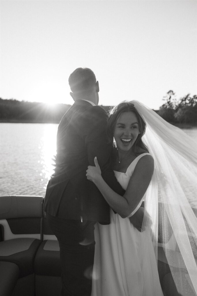 Bride clutches groom's arms with a jubilant look on her face