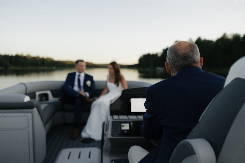 Father of the groom takes Minnesota newlyweds on a sunset cruise on Lake Leech in Walker, Minnesota