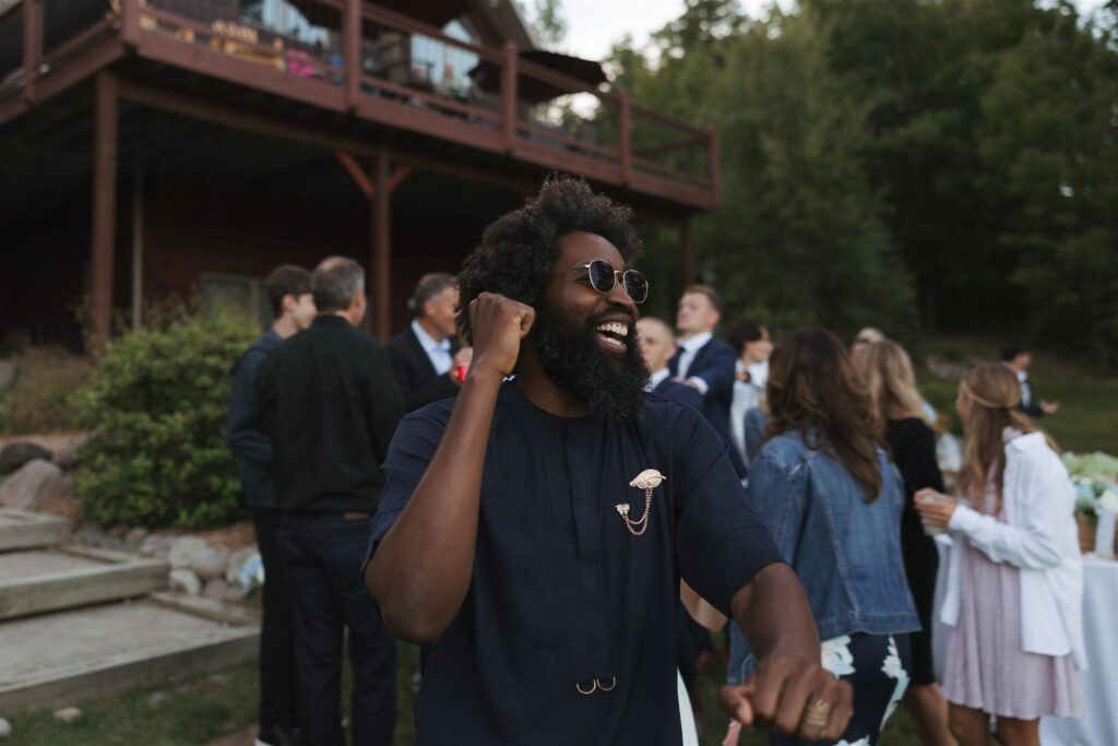 DJ smiles at all of the wedding guests