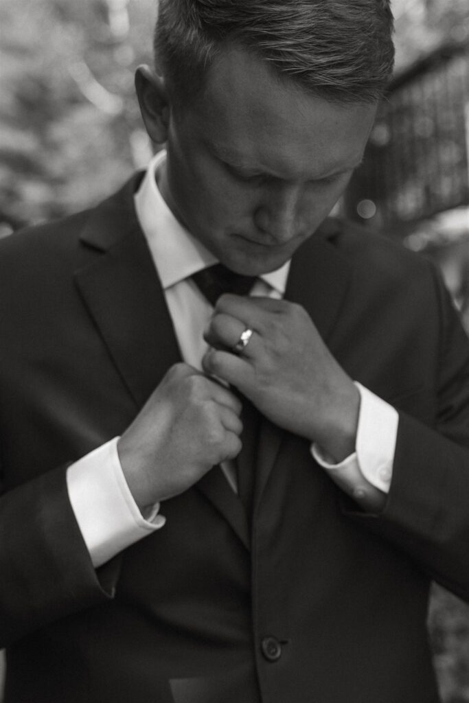 Groom fixes his ties