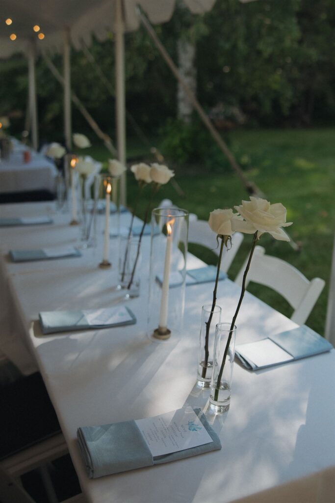 Simple white roses and candlesticks serve as the tablescapes for Walker, Minnesota wedding