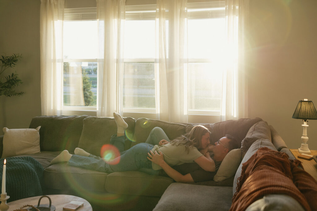 Couple lays on couch of their Minnesota home