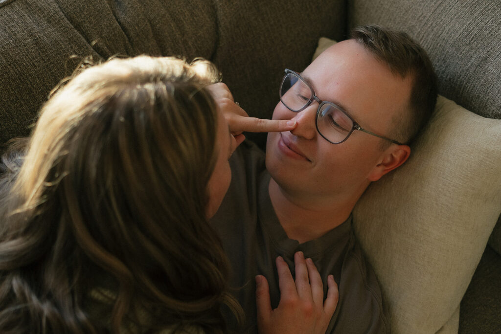 Woman presses her finger gently to her husband's nose