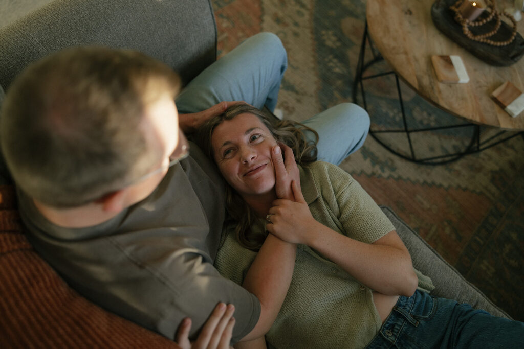 Man cradles woman's head in his hands