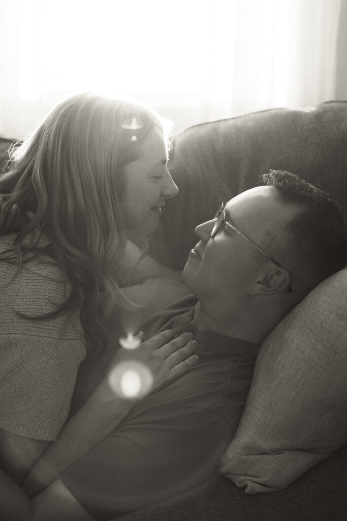 Minnesota couple lays together on the couch of their home