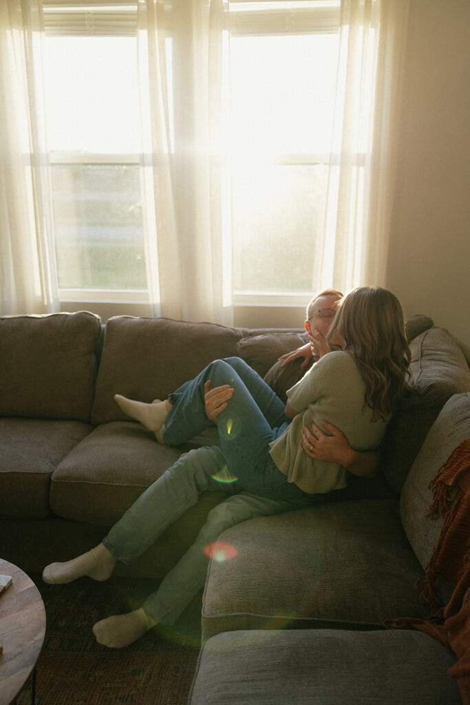 Married couple snuggles on the couch during their Minnesota couples photography session