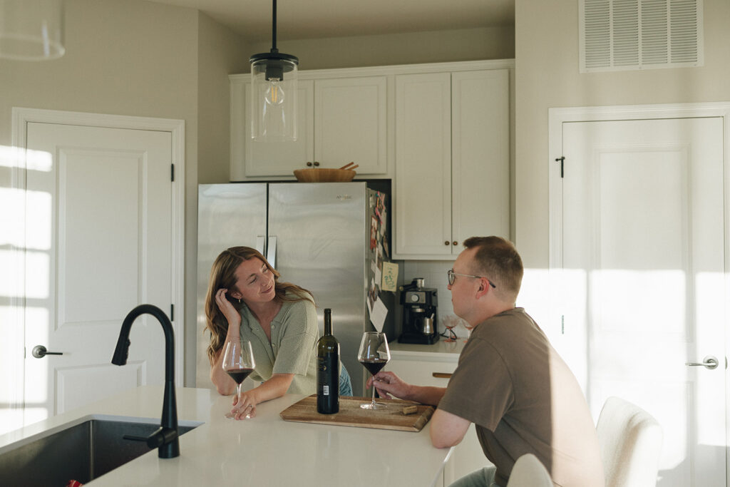 Man and woman share a glass of wine together during their Minnesota couples photography session