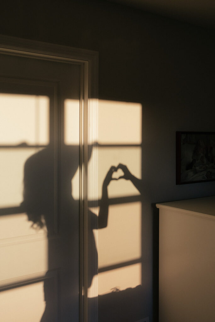 Married couple creates a shadow heart on the wall of their bedroom