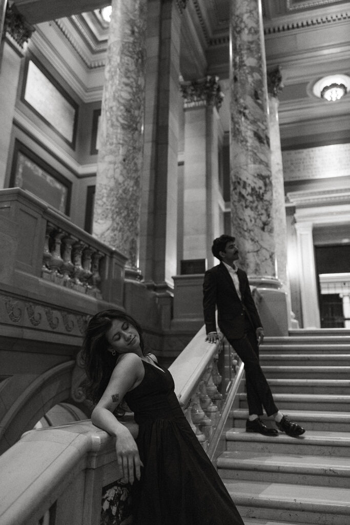 Low-angle couple shot with Capitol columns towering above