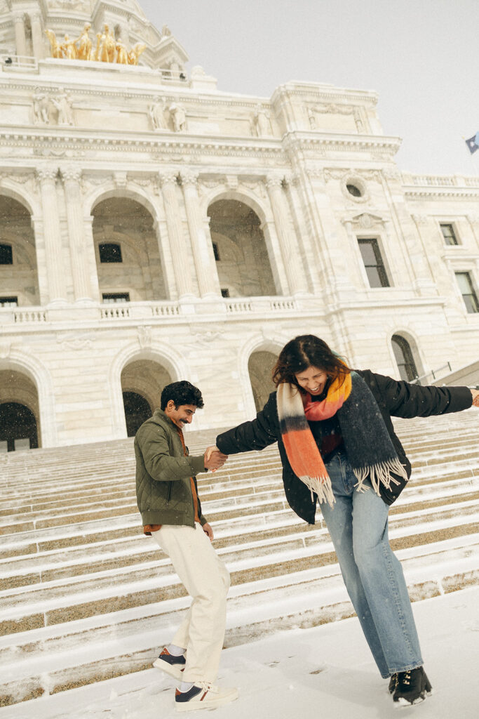 Couples romps in the snow for cinematic engagement image