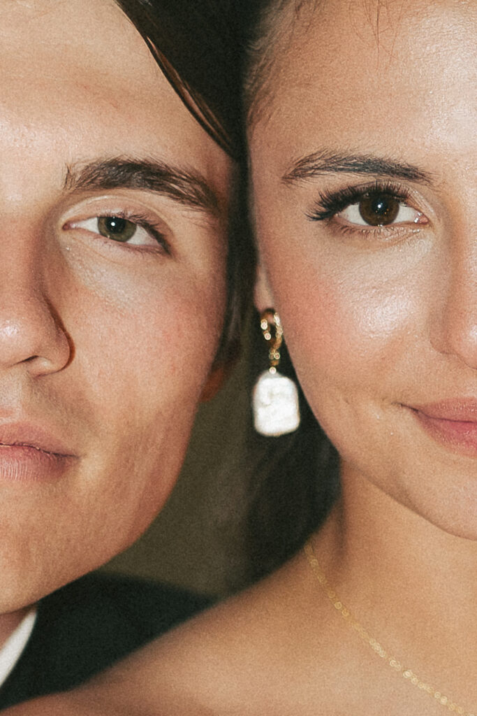 Close up of bride's and groom's softly smiling faces, cheek to cheek